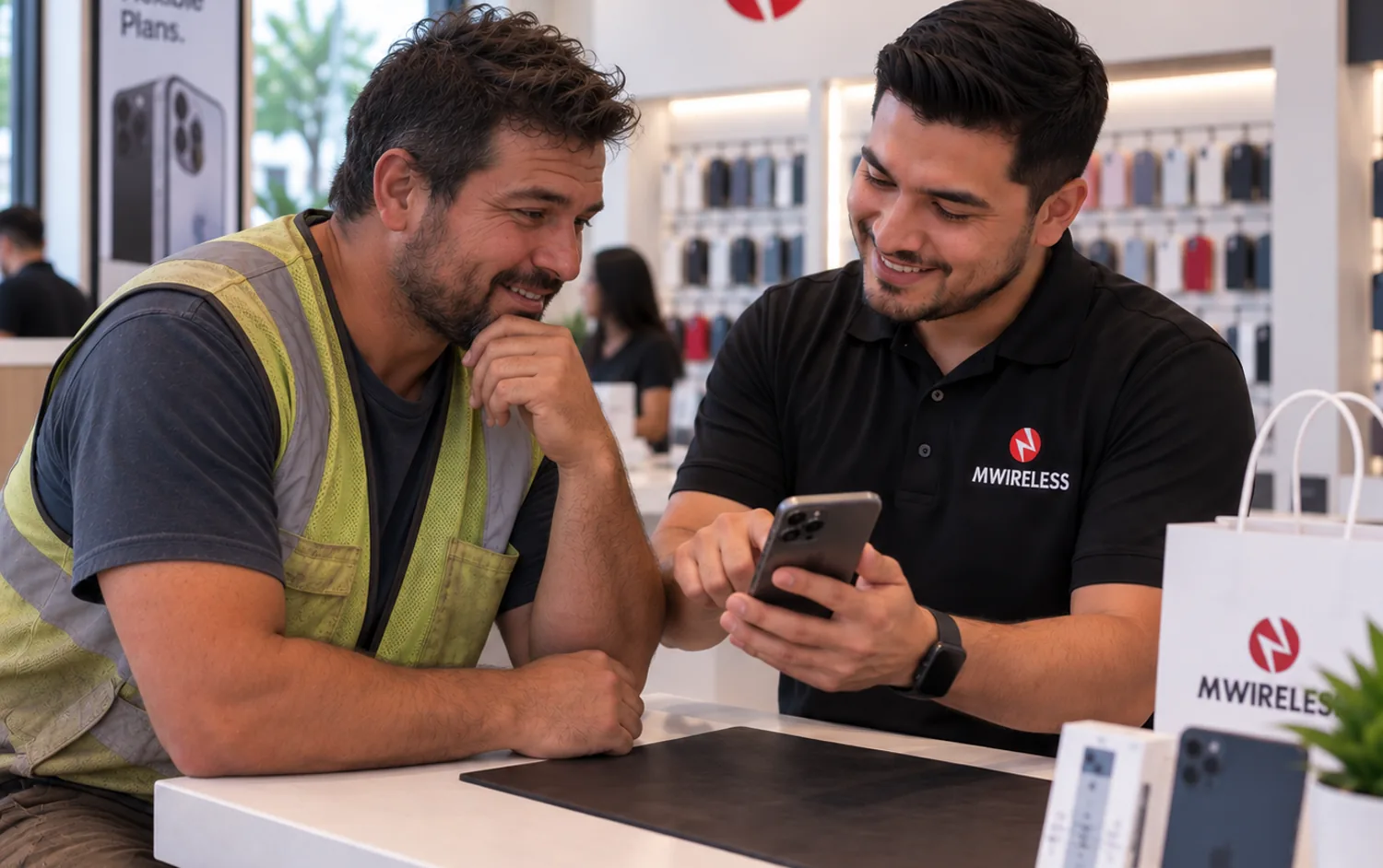 MWireless technician showing a customer her cracked phone screen at the store counter